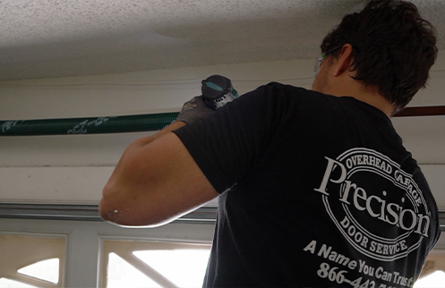 Technician Repairing Garage Door